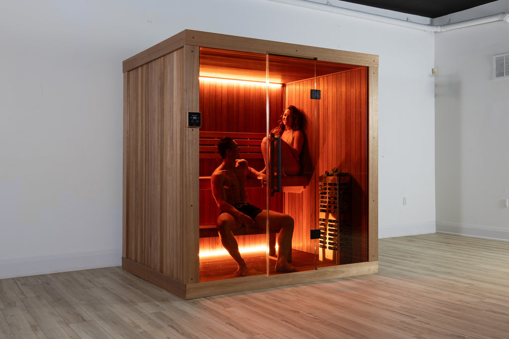 Two people relaxing inside the LeisureCraft Element Studio sauna, seen through the glass front