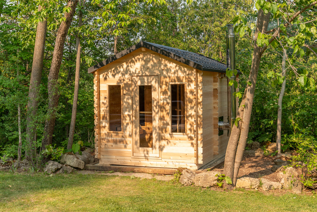 LeisureCraft Georgian cabin sauna in a garden setting with stone landscaping